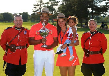 OAKVILLE, ON - JULY 30:  Jhonattan Vegas of Venezuela poses with his wife Hildegard, daughter Sharlene, 16 months, and the trophy along with Canadian Mounties following the final round of the RBC Canadian Open at Glen Abbey Golf Club on July 30, 2017 in Oakville, Canada.  (Photo by Vaughn Ridley/Getty Images)