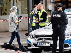 Police officers securing evidence in front of the supermarket in Hamburg, Germany, Friday, July 28, 2017, where a man with a knife fatally stabbed one person and wounded six others. (AP)
