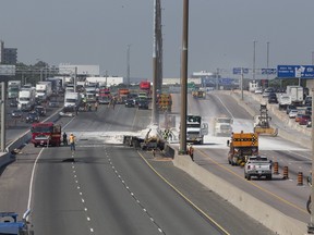 Crews work to clean up Hwy. 401 near Avenue Rd. after a fatal collision on Monday, July 31, 2017. (Stan Behal/Toronto Sun)
