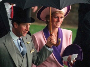 In this Wednesday, June 20, 1990 file photo, Britain's Princess Diana and Prince Charles, take shelter under an umbrella while attending the second day of the Royal Ascot horse race meet near London. A British television channel is broadcasting a new documentary on Princess Diana using video tapes in which she candidly discussed her marital problems and her strained relationship with the royal family. (AP Photo/Martyn Hayhow, File)