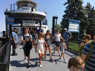 Visitors exit a ferry at Toronto Islands on Monday, July 31, 2017. (Craig Robertson/Toronto Sun)