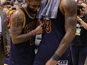 Cleveland Cavaliers' LeBron James, right, and Kyrie Irving celebrate after Cleveland defeated the Indiana Pacers 106-102 to win Game 4 of a first-round NBA basketball playoff series, Sunday, April 23, 2017, in Indianapolis. Cleveland won the series 4-0. (AP Photo/Darron Cummings)