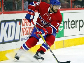 In this Feb. 2, 2017, file photo, Montreal Canadiens' Andrei Markov moves the puck during an NHL hockey game in Philadelphia. Longtime Montreal Canadiens defenseman Markov has signed with the Russian Kontinental Hockey League club Ak Bars Kazan, it was reported on Monday, July 31, 2017.