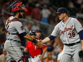 In this July 21, 2017, file photo, Detroit Tigers catcher Alex Avila and relief pitcher Justin Wilson celebrate the team's 6-3 win over the Minnesota Twins, in a baseball game in Minneapolis. The pair were traded to the Chicago Cubs ahead of the July 31st trade deadline. (AP Photo/Bruce Kluckhohn, File)