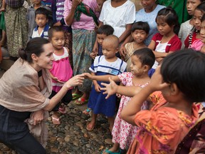 In this handout photo provided by the Maddox Jolie-Pitt Foundation, actress and activist Angelina Jolie Pitt meets children during a visit to Ja Mai Kaung Baptist refugee camp on July 30, 2015 in Myitkyina, Myanmar. Angelina Jolie Pitt is a Special Envoy of UN High Commissioner for Refugees since her 2012 appointment. (Photo by Tom Stoddart/Getty Images Reportage/Maddox Jolie-Pitt Foundation via Getty Images)