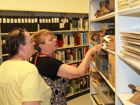 A pair of Lambton County residents look at some of the county's historical records and documents during a July 21 tour. The Lambton County Archives offered free tours following a six-week, $200,000 renovation at their Wyoming facility. 
CARL HNATYSHYN/SARNIA THIS WEEK