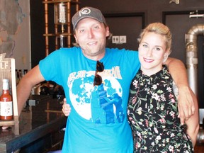 Top Shelf Collection's Josh Lines and Carly McFadden show off their new Front Street Heat hot sauce in Blackwater Coffee, one of 23 locations in Sarnia that feature the hot sauce. (Carl Hnatyshyn/Postmedia Network)