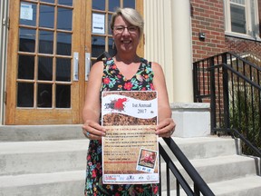 Julie Hayes, community relations co-ordinator for Bridges Out of Poverty, stands with a poster for the Junior Jumbo Mud Challenge happening in St. Thomas on Sept. 9 as a fundraiser for YWCA programs. (Laura Broadley/Times-Journal)