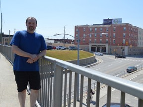 Tom Parker stands on the former rail bridge on Algonquin Avenue, where a rock either fell or was thrown onto his windshield Wednesday night. Parker is warning other drivers to be cautious when driving under the bridge.