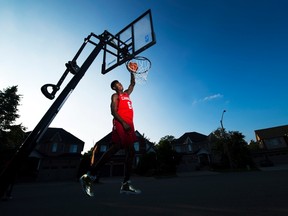 R.J. Barrett, 17, dunks the ball outside his home in Mississauga, Ont., on July 20, 2017. (THE CANADIAN PRESS/Nathan Denette)