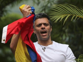 In this Saturday, July 8, 2017, file photo, Venezuela's opposition leader Leopoldo Lopez holds a national flag as he greets supporters outside his home in Caracas, Venezuela, following his release from prison and being placed under house arrest after more than three years in military lockup. Allies of two Venezuelan opposition leaders say Lopez and Antonio Ledezma have been taken by authorities from the homes where they were under house arrest. Video posted on the Twitter account of Lopez's wife early Tuesday, Aug. 1, shows a man being taken away from a Caracas home by state security agents. (AP Photo/Fernando Llano, File)