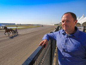 Paul Ryneveld, General Manager at Century Downs Racetrack and Casino looks out on the track as horses train on Thursday morning July 27, 2017. Gavin Young/Postmedia