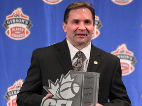 FILE PHOTO - 
Edmonton Eskimos equipment manager Dwayne Mandrusiak holds his trophy as the CFL Commissioner’s Award winner at the CFL player awards ahead of the 2013 Grey Cup in Regina.