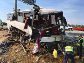 In this Aug. 2, 2016, file photo, authorities investigate the scene of a charter bus crash on northbound Highway 99 between Atwater and Livingston, Calif. The Merced County District Attorney's office on Monday, July 31, 2017, filed four felony counts of vehicular manslaughter and five misdemeanor vehicle code violations against the driver Mario David Vasquez in connection with the crash last August amid San Joaquin Valley farmland. (AP Photo/Scott Smith, File)
