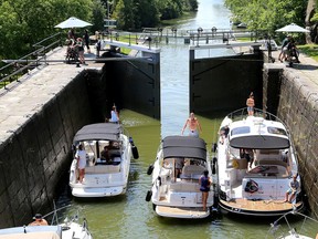 Pleasure boats head southbound through the locks at Kingston Mills on Tuesday. Some locks, including Kingston Mills, Upper Brewers and Lower Brewers have been closed for a week due to high water levels stranding boaters.  (Ian MacAlpine /The Whig-Standard)