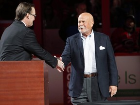 In this Feb. 13, 2016, file photo, Carolina Hurricanes broadcaster John Forslund greets Hurricanes owner Peter Karmanos Jr., right, before the teams' NHL hockey game against the New York Islanders in Raleigh, N.C. Karmanos Jr. says he wants to sell his team for about $500 million. (THE CANADIAN PRESS/AP/Karl B DeBlaker)