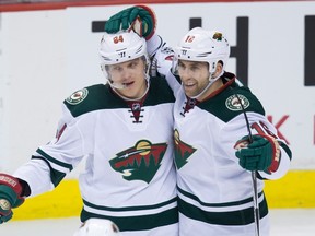 Minnesota Wild's Mikael Granlund, left, of Finland, and Jason Zucker celebrate Granlund's third goal during third period NHL hockey action against the Vancouver Canucks, in Vancouver on Saturday, February 4, 2017. (THE CANADIAN PRESS/Darryl Dyck)