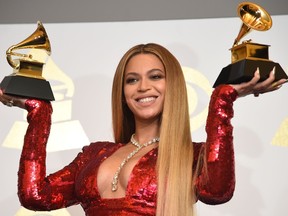 Singer Beyonce poses with her Grammy trophies in the press room during the 59th Annual Grammy music Awards on February 12, 2017, in Los Angeles, California. / AFP / Robyn BECK (Photo credit should read ROBYN BECK/AFP/Getty Images)