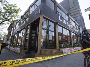 Toronto Police investigate a late-night homicide on the patio of the Libertarian at Queen Street East and Sherborne St. in Toronto, on Tuesday, August 1, 2017. (STAN BEHAL/TORONTO SUN)