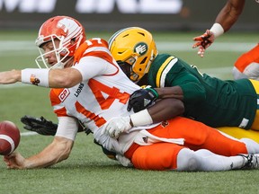 B.C. Lions quarterback Travis Lulay (14) fumbles the ball after being sacked by Edmonton Eskimos defensive end Odell Willis (41) during first half CFL action in Edmonton, Alta., on Friday July 28, 2017.