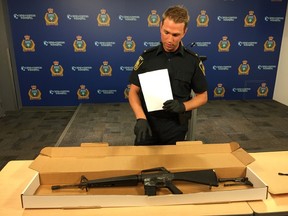 Winnipeg police spokesperson Const. Jay Murray shows off an AR15 semi-automatic rifle seized following the execution of a Criminal Code search warrant in a residence in the 500 block of Redwood Avenue in Winnipeg at around 12:45 p.m., on Thursday, July 27, 2017, at a media briefing on Tuesday, Aug. 1, 2017. Among the items also seized by police was a cattle prod. JASON FRIESEN/Winnipeg Sun/Postmedia Network