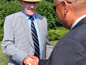 Jim Downey (left) and Norway House Chief Ron Evans, co-chairs of the Engagement Initiative to Develop a Mineral Development Protocol with First Nations communities, shake hands after a press conference at the Manitoba Legislative grounds in Winnipeg on Tues., Aug. 1, 2017. Kevin King/Winnipeg Sun/Postmedia Network