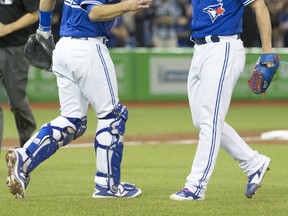Toronto Blue Jays catcher Luke Maile celebrates the Jays win with reliever Roberto Osuna as the Jays beat the Seattle Mariners in Toronto on May 13, 2017. (Stan Behal/Toronto Sun/Postmedia Network)