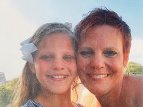 In this undated photo provided by Dianne Grossman, Grossman, right, poses with her daughter Mallory Grossman. The New Jersey mother is suing her late daughter's school district because she says they didn't do enough to stop cyber bullying against her daughter that led the 12-year-old to kill herself. (Courtesy of Dianne Grossman via AP)