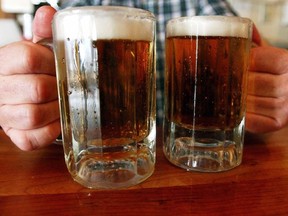 In this June 29, 2004 file photo, a bartender serves two mugs of beer at a tavern in Montpelier, Vt. A new poll suggests the binge-drinking habits of Montrealers are firmly divided along linguistic lines.The survey commissioned for Educ'alcool by polling firm CROP indicates English-speaking Montrealers are more likely to drink to excess than their francophone counterparts, with allophones consuming even less alcohol. THE CANADIAN PRESS/AP/Toby Talbot, File