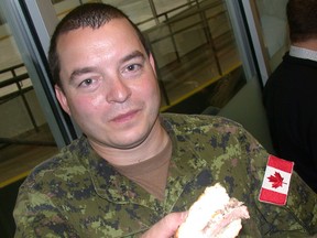 Paul Svoboda/The Intelligencer
Corporal Rene Valliere of 8 Wing Trenton samples beer-braised beef brisket on an onion bun during a Belleville Senators press conference Wednesday at the Quinte Sports and Wellness Centre. B-Sens announced a partnership with Spectra for food, beverage and hospitality operations at AHL home games next season at Yardmen Arena.