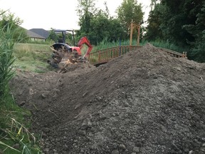 Dirt is pictured piled on the Howard Watson Nature Trail after excavation work on a backyard pool Sunday. Sarnia staff are looking to update permitting requirements for work involving access from the trail or city parks. (Handout)