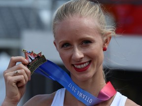 Sage Watson of Medicine Hat, Alta., displays her gold medal after winning the women's 400-metre hurdles race at the Canadian Track and Field Championships in Ottawa, Sunday, July 9 2017. (THE CANADIAN PRESS/Fred Chartrand)