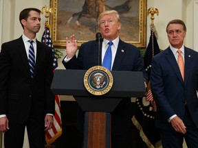 President Donald Trump, flanked by Sen. Tom Cotton, R- Ark., left, and Sen. David Perdue, R-Ga., speaks in the Roosevelt Room of the White House in Washington, Wednesday, Aug. 2, 2017, during the unveiling of legislation that would place new limits on legal immigration. (AP Photo/Evan Vucci)