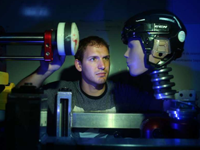 David Koncan, a Phd candidate in the Neurotrauma Impact Science lab at the University of Ottawa, measures impact on a head with a linear impactor machine.