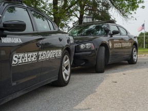 Nebraska State Patrol vehicles are parked in a state patrol facility in Omaha, Neb., Wednesday, Aug. 2, 2017. A federal lawsuit accuses the Nebraska State Patrol that it has for years forced female recruits to submit to invasive, medically unnecessary pelvic exams performed by a male doctor before they can be hired. (AP Photo/Nati Harnik)