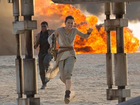 This photo provided by Disney/Lucasfilm shows Daisy Ridley, right, as Rey, and John Boyega as Finn, in a scene from the film, "Star Wars: The Force Awakens," directed by J.J. Abrams. (David James/Disney/Lucasfilm via AP)