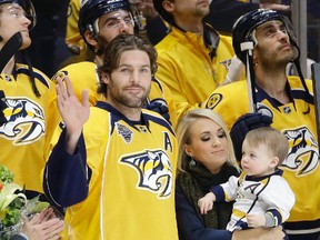 Predators forward Mike Fisher, with his wife Carrie Underwood and son Isaiah, was honoured for his 1,000th NHL game in Nashville, Tenn., on March 21, 2016. Fisher has announced his retirement after 17 NHL seasons on Thursday, Aug. 3, 2017. (Mark Humphrey/AP Photo/Files)
