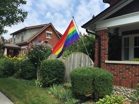 Two pride flags now billow in the wind on Tecumseh Street in London's Old South neighbourhood Thursday. The one on the right was replaced after vandals tore it down and burned holes in it overnight July 24, an incident London police are now investigating as a hate crime. (JENNIFER BIEMAN, The London Free Press)