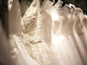 In this stock photo, a shopping rack is seen full of white wedding dresses with different styles and sizes. (Getty Images)