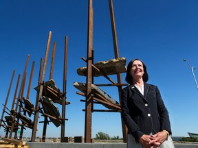 The City of Calgary's Manager of Arts and Culture Sarah Iley stands near the Bowfort Towers public art installation at the Trans Canada Highway and Bowfort Road interchange on Thursday August 3, 2017. Bowfort Towers was created by artist Del Geist using steel beams with Rundle rock suspended within them. The towers are one half of the public art at the interchange with another piece to be installed on the north side of the highway.