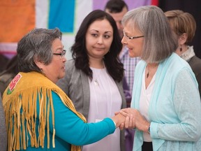 Chief Commissioner Marion Buller (right) greets Frances Neumann after she told a story about her murdered sister-in-law Mary Johns at the National Inquiry into Missing and Murdered Indigenous Women and Girls taking place in Whitehorse, Yukon, May 30, 2017. THE CANADIAN PRESS/Jonathan Hayward