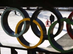 A young girl learns to skate on the ice at the 1988 Calgary Olympic Plaza on a warm day in Calgary in this 2014 file photo. Calgary city council has voted to continue exploring a potential bid for the 2026 Winter Olympics. THE CANADIAN PRESS/Jeff McIntosh