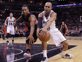 Toronto Raptors’ Kyle Lowry (7) and San Antonio Spurs’ Patty Mills (8) chase a loose ball during the first half of an NBA basketball game, Tuesday, March 10, 2015, in San Antonio. (AP Photo/Eric Gay)