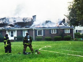 In this photo provided by Fayette County Department of Fire & Emergency Services , a home burns during a fire on Sunday, July 30, 2017, in Fayetteville, Ga. According to authorities, the blaze started when the homeowners lit a small stick on fire in an attempt to remove some bees near a gutter. (Fayette County Department of Fire & Emergency Services via AP)