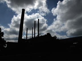 The afternoon sun silhouetted the smoke stacks on the Heinz plant in Leamington on Thursday, June 26, 2014. After over a century of business in the town, Heinz closed the factory. (It later reopened under a new owner, though with only a third the workers it had before.) Tyler Brownbridge, Postmedia