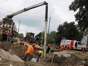 Crews work to replace a damaged water main on Colborne Road Friday. It was one of several in Sarnia to break after power outages led to surges from the Lambton Area Water Supply System (LAWSS) plant. (Tyler Kula/Sarnia Observer/Postmedia Network)