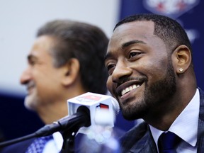 Washington Wizards NBA basketball point guard John Wall, with Wizards majority owner Ted Leonsis at left, speaks to reporters during a news conference to announce NBA star John Wall's contract extension, Friday, Aug. 4, 2017, in Washington. (AP Photo/Manuel Balce Ceneta)