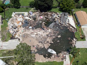 A large sinkhole in the Lake Padgett Estates community grew overnight, Friday, Aug. 4, 2017 in Land O' Lakes, Fla. (Luis Santana Tampa Bay Times via AP)