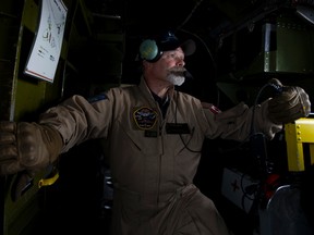 Flight load master John Roberts looks out a window of the 1944 "Maid in the Shade" B-25J Mitchell bomber, during a flight from the Villeneuve Airport, west of Edmonton Friday Aug. 4, 2017. David Bloom / Postmedia