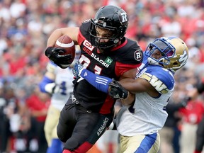 Ottawa's Patrick Lavoie runs into Winnipeg's Moe Leggett on a carry during CFL action at TD Place on Aug. 4, 2017. (Julie Oliver/Postmedia)